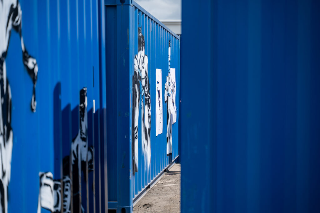 The Rebel Bear’s street art painted on blue BOXXS Self Storage containers at the Linlithgow exhibition.