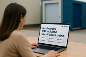 Woman viewing Boxxs Self Storage pricing on a laptop, with blue drive-up units in the background. Prices shown include VAT and no deposit required
