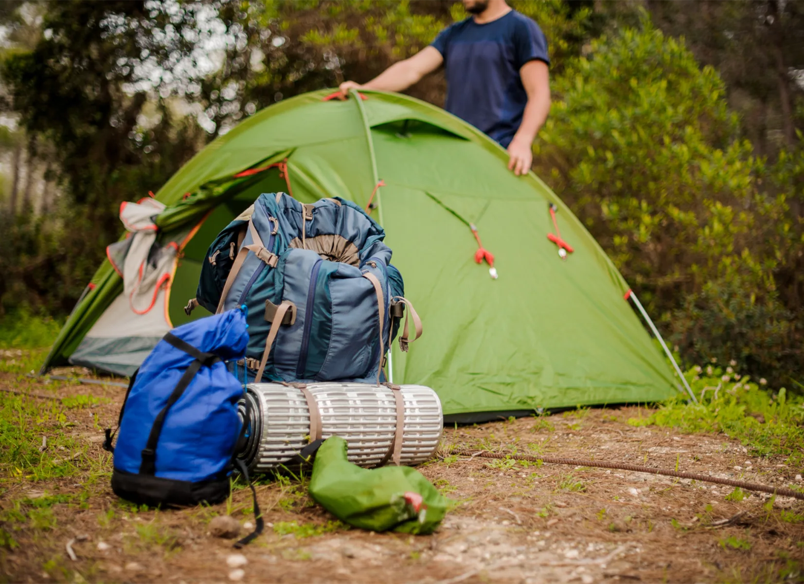 How to store camping equipment between trips with tents, sleeping bags, folding chairs and labelled storage boxes neatly organised.
